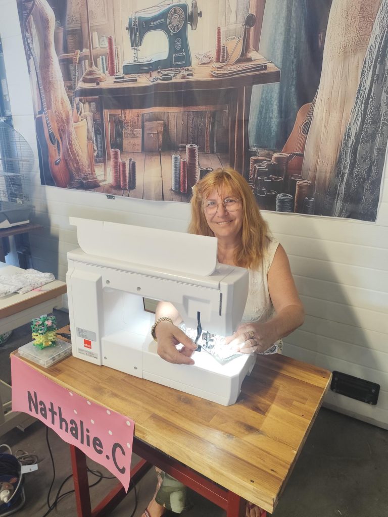 Nathalie,c dans son atelier devant une machine